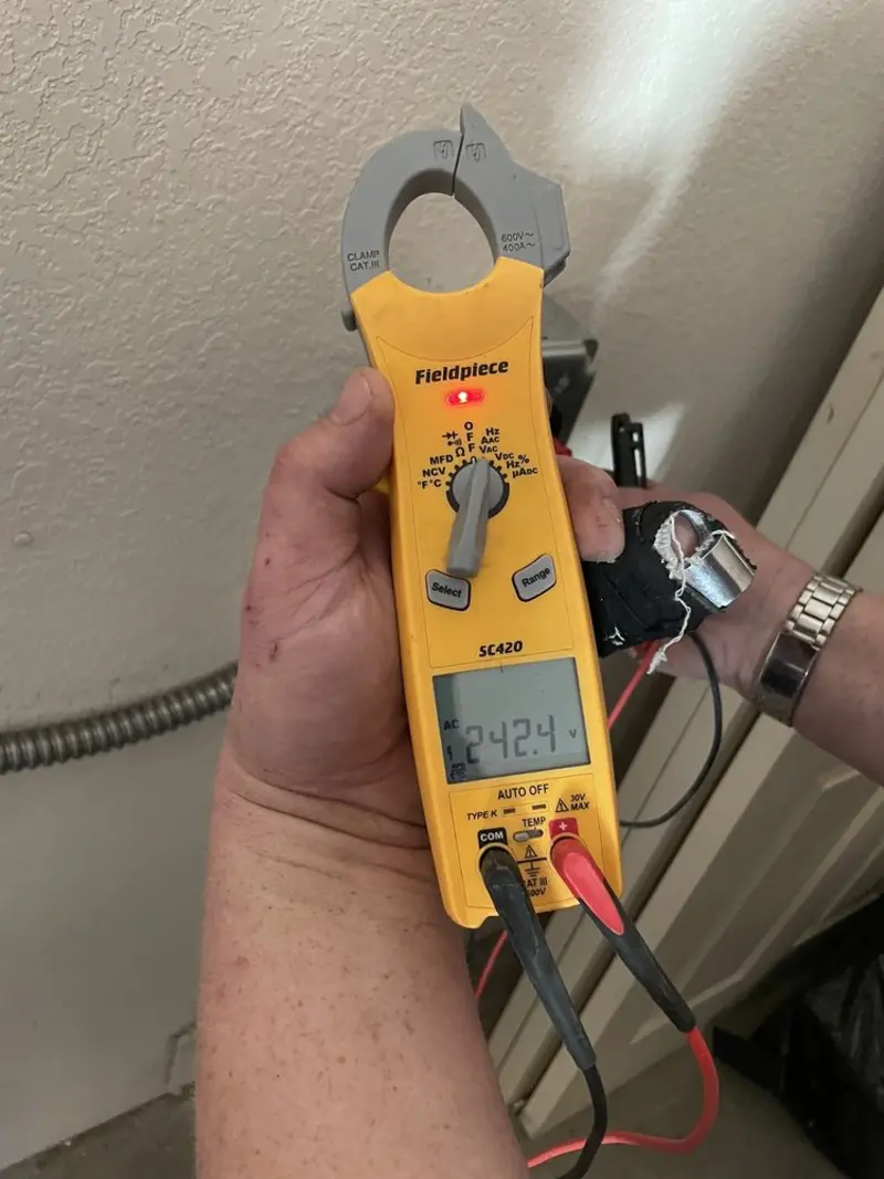 Voltage testing with clamp meter during Outlet Installation in Roma